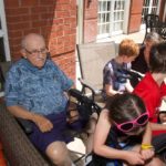senior resident with kids at butterfly release event