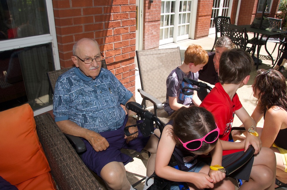 senior resident with kids at butterfly release event