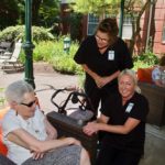 arbors staff with senior resident at butterfly release event