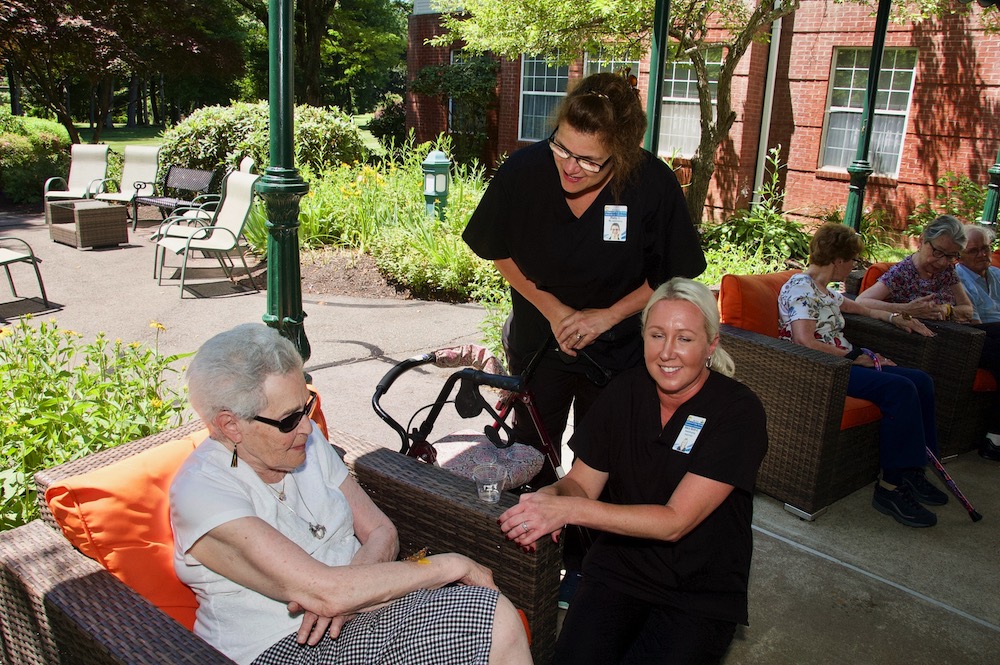 arbors staff with senior resident at butterfly release event