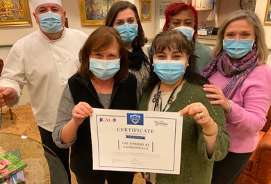 arbors of hop brook staff holding certificate