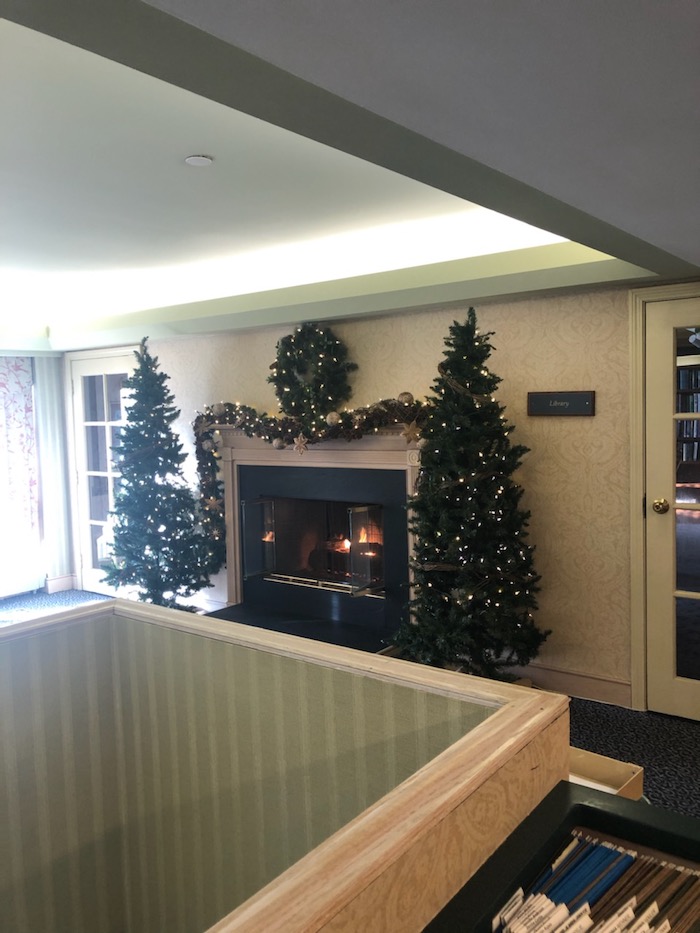 indoor fireplace with christmas decorations at arbors