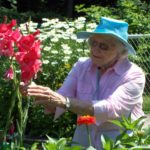 senior resident tending to flowers in garden