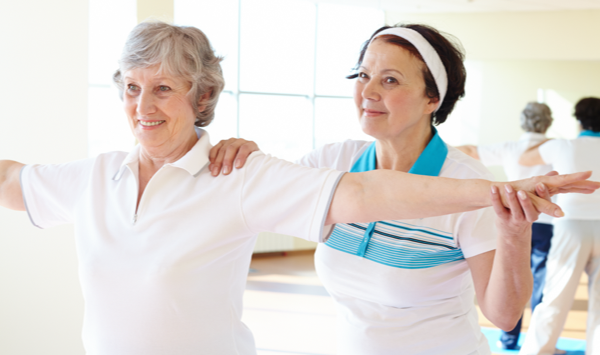 senior resident yoga with instructor