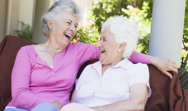 two senior women laughing outside