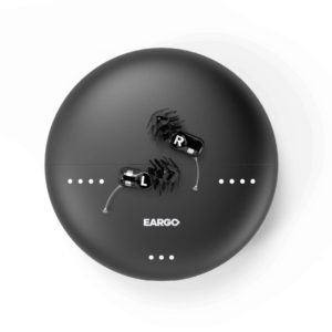 small black hearing aids on top of a black circular charging case