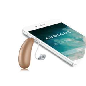 small brown hearing aid next to a smartphone 