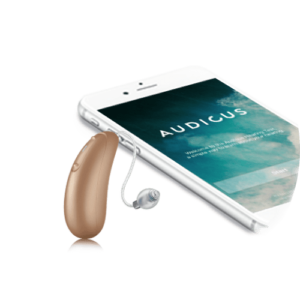 small brown hearing aid next to a smartphone 