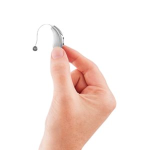 hand holding up a small hearing aid