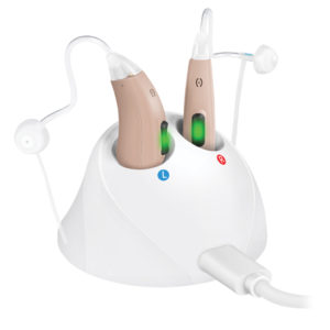 tan hearing aids in a white charging doc 