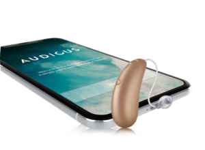gold hearing aid next to a smartphone 